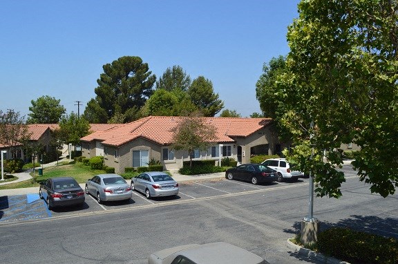 a neighborhood with cars parked in a parking lot