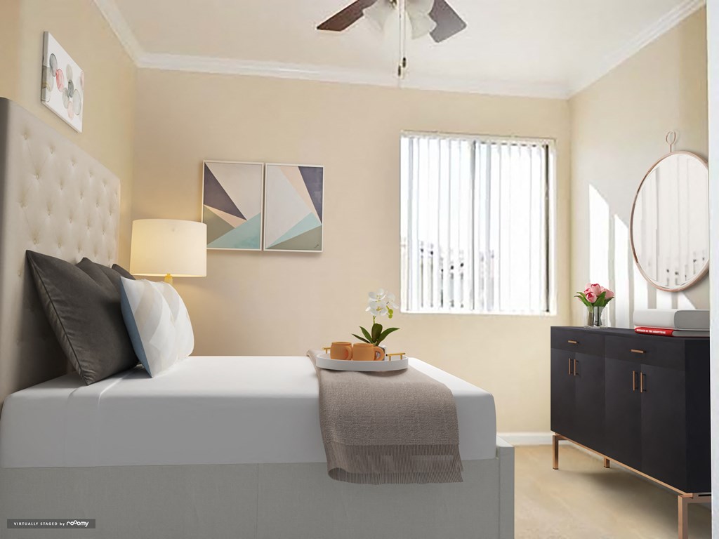 a bedroom with a bed and a dresser and a window