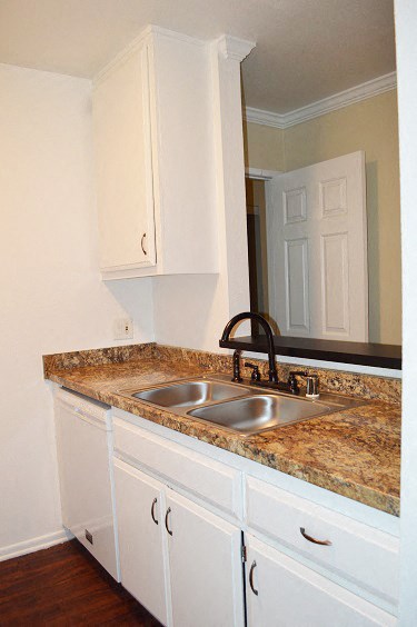 a kitchen with white cabinets and a sink