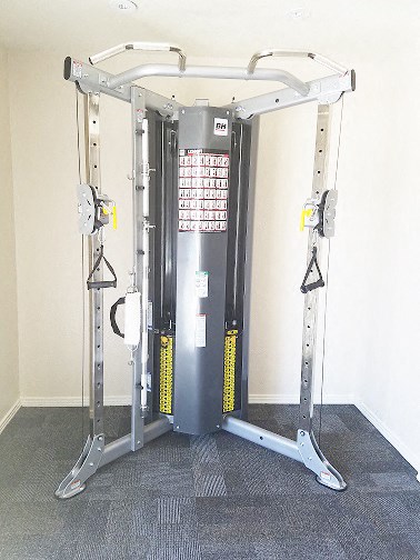 a gym room with a machine in the corner