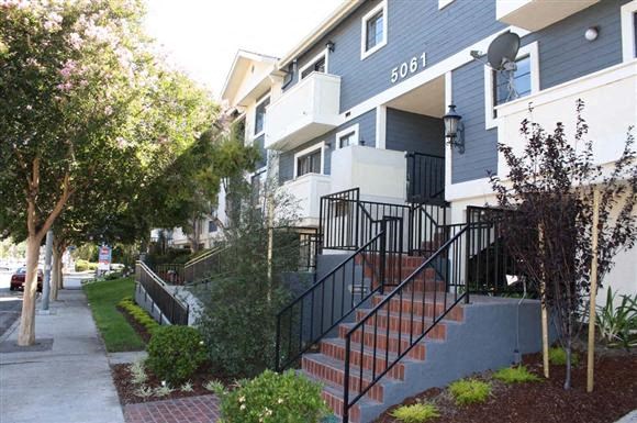 an apartment building with stairs in front of it