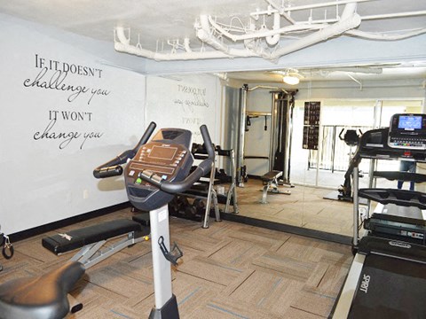 a workout room with a whiteboard and exercise equipment