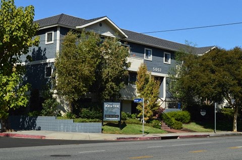 a house with a sign in front of it on a street