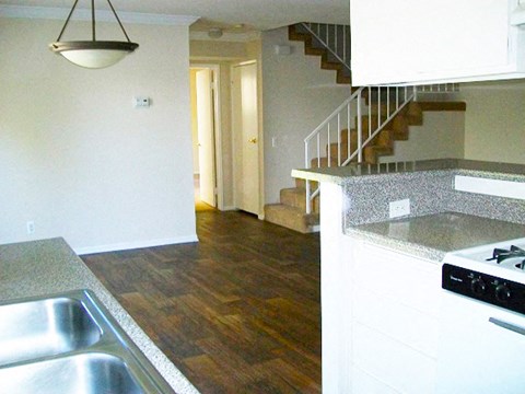 an empty kitchen with a stove and a staircase