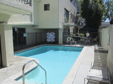 a swimming pool in front of an apartment building
