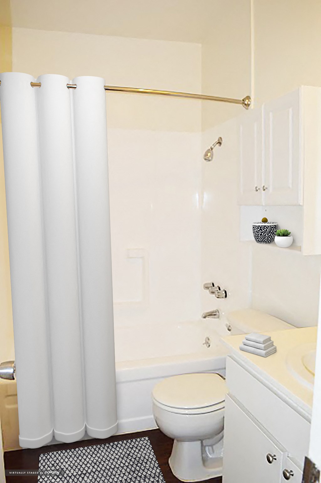 a white bathroom with a shower curtain and a toilet
