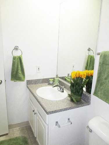 a white bathroom with a sink and a mirror