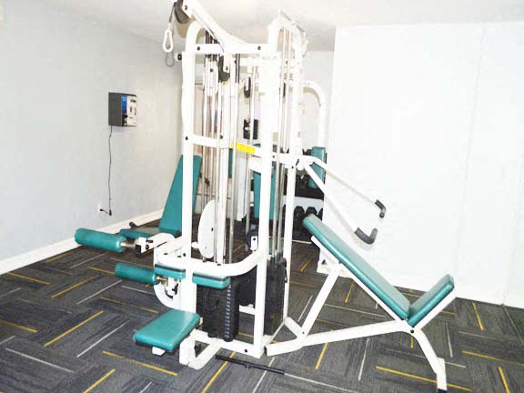 a gym with a weight machine in a white room