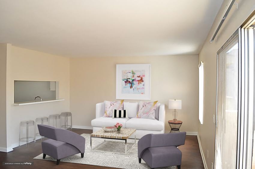 a living room with a couch and chairs and a table