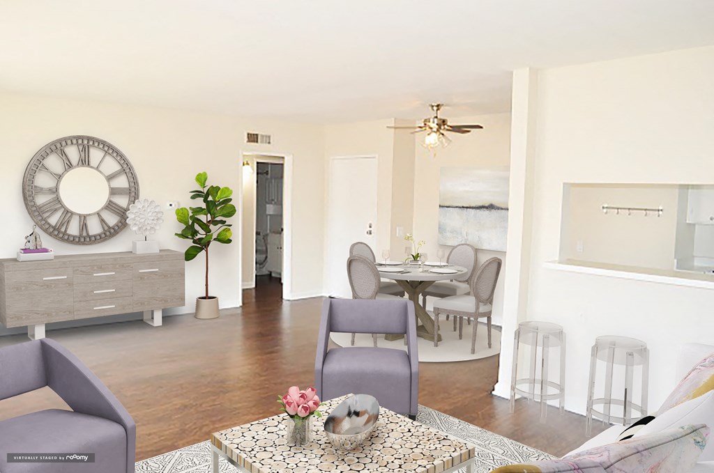 a living room and dining room with a large clock on the wall