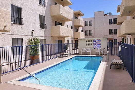 a swimming pool in front of an apartment building