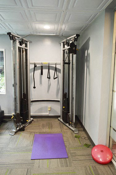a fitness room with a yoga ball and exercise equipment