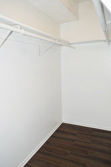 an empty room with white walls and a wooden floor