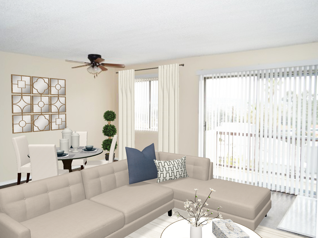 a living room with a couch and a ceiling fan