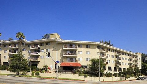 a large apartment building on the corner of a street