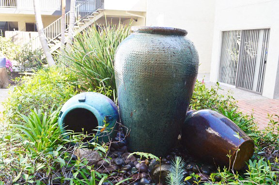 two large vases are sitting in the grass