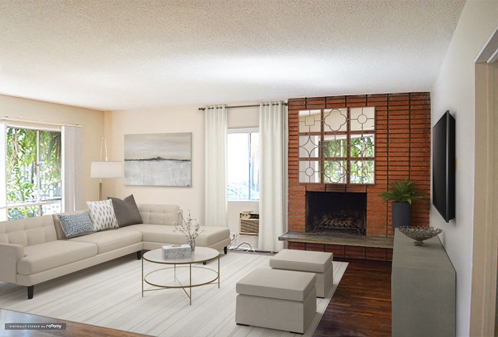 a living room with a fireplace and a couch and a table