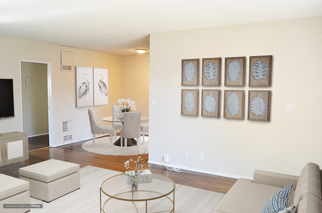 a living room with furniture and paintings on the wall