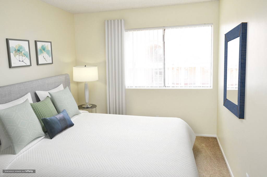 a bedroom with a large bed and a window