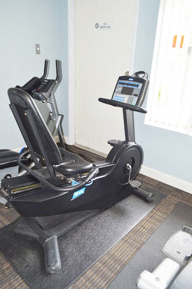 a gym with an exercise bike on the floor