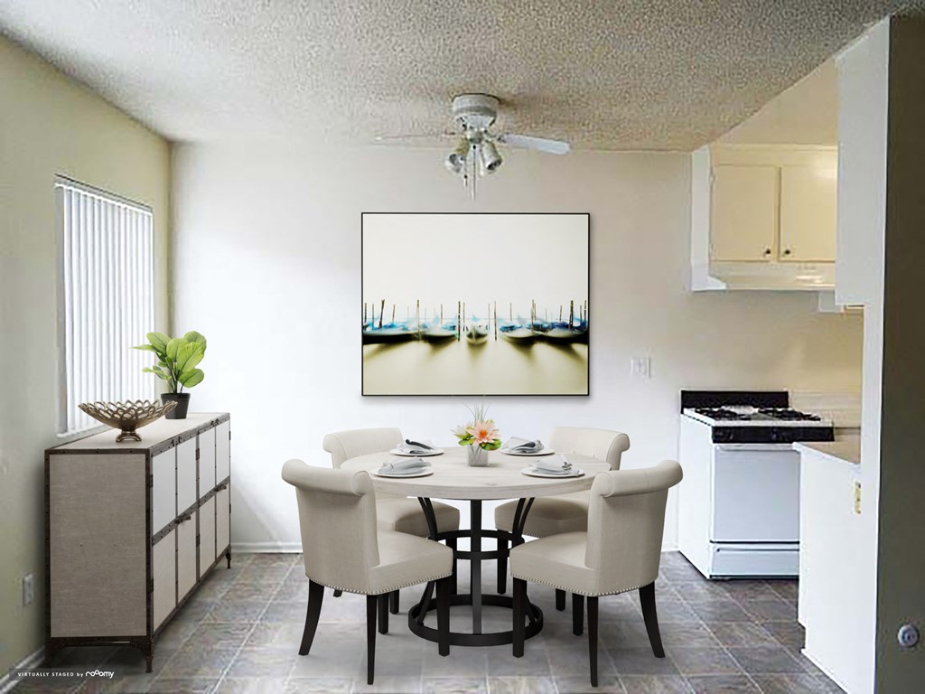 a kitchen and dining room with a table and chairs