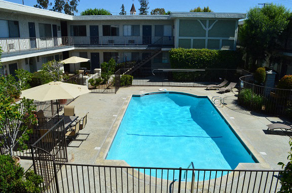 a swimming pool in the middle of a hotel courtyard