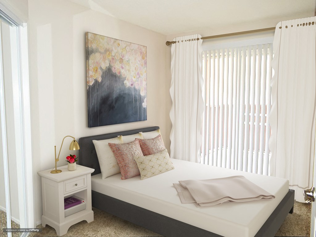 a bedroom with a bed and a painting on the wall