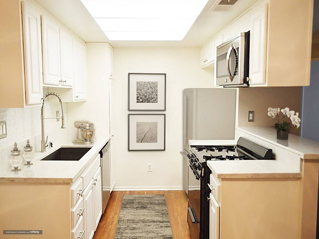 a kitchen with a stove and a microwave and a sink