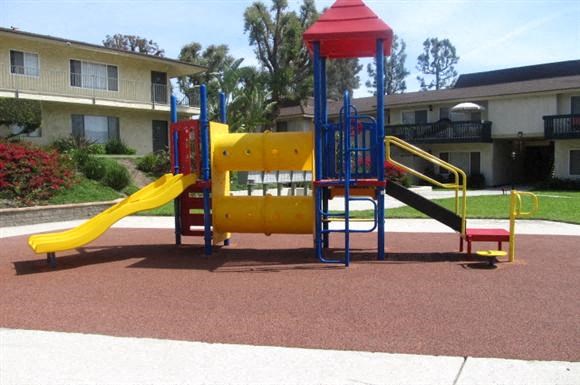 a playground with a yellow and blue swing set