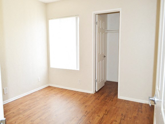 an empty room with a door and a window