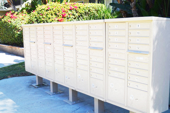 a row of white lockers in front of a garden
