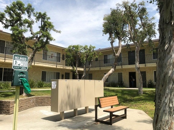 a bench in a park in front of a building
