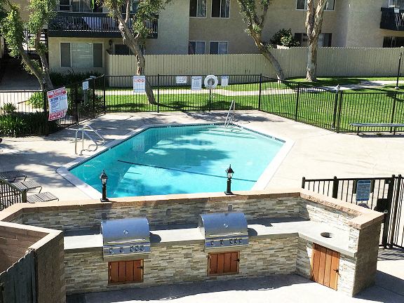 a swimming pool in front of an apartment building