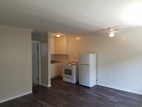 an empty kitchen with a refrigerator and a stove