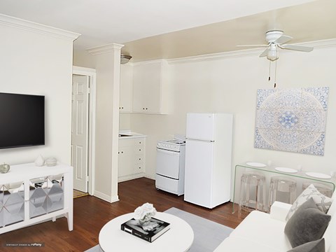 A living room with a white couch and a television.