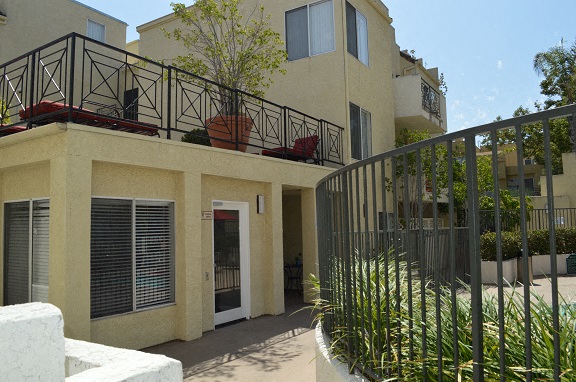 an apartment building with a balcony and a gate