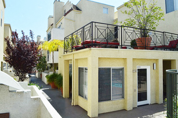 an apartment building with a balcony and a door
