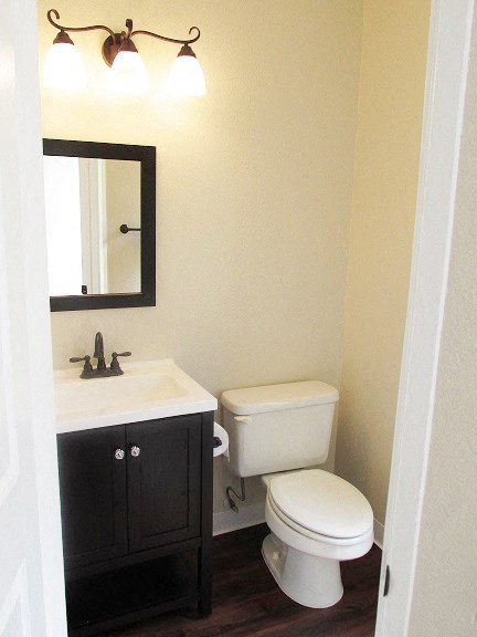a bathroom with a toilet and a sink and a mirror