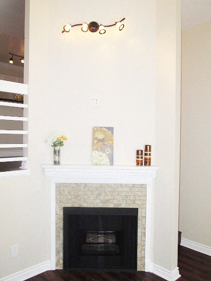 a living room with a fireplace and a chandelier