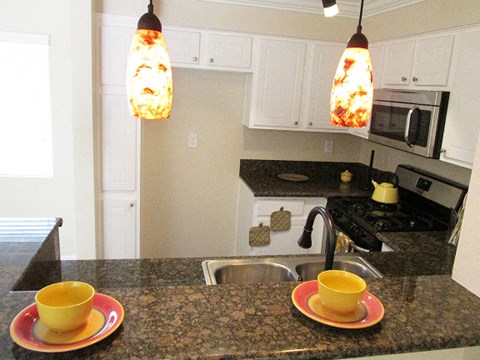 a kitchen with two cups on a counter