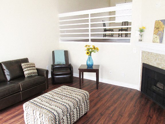 a living room with leather furniture and a fireplace