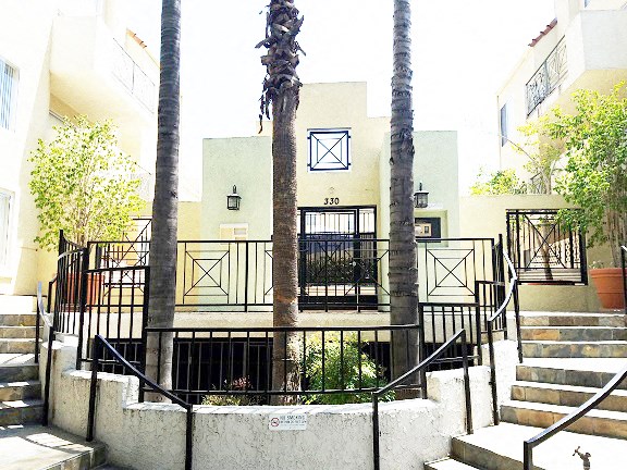 a building with three palm trees in front of it