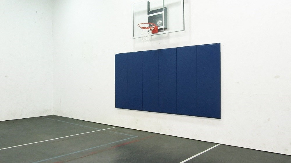 a large blue wall with a basketball hoop on it