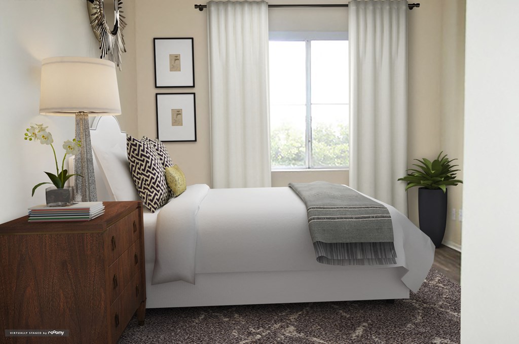 a bedroom with a white bed and a window