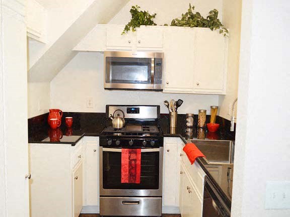 a small kitchen with a stove and a microwave