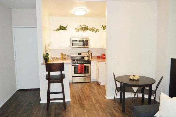 a small kitchen with a table and chairs