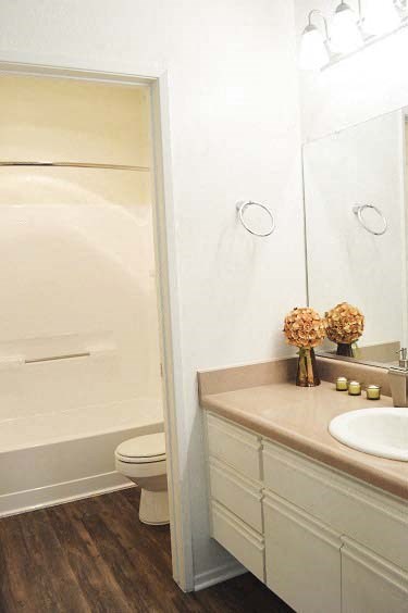 a bathroom with a toilet and a sink and a shower