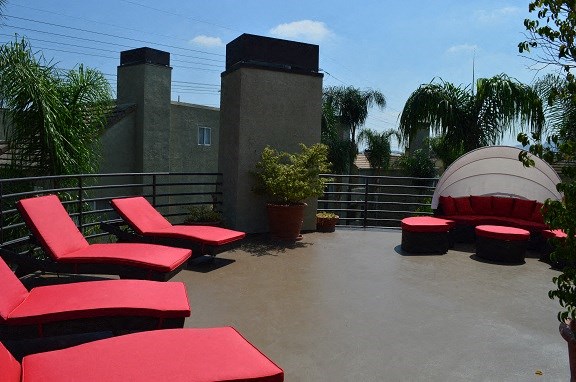 a group of red couches and chairs on a roof