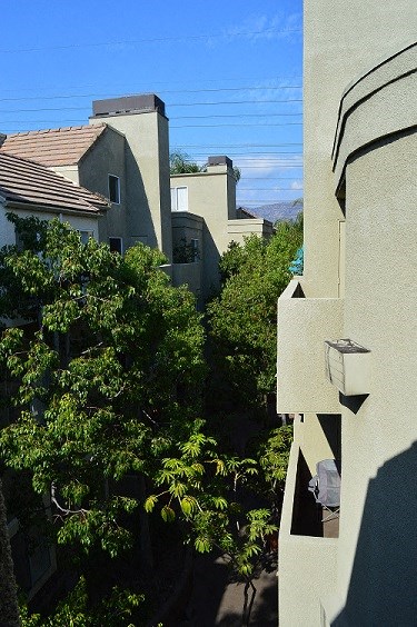 a view of some buildings from a balcony