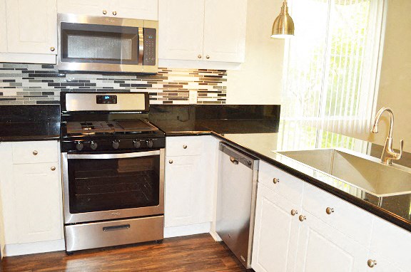 a kitchen with a stove and a microwave